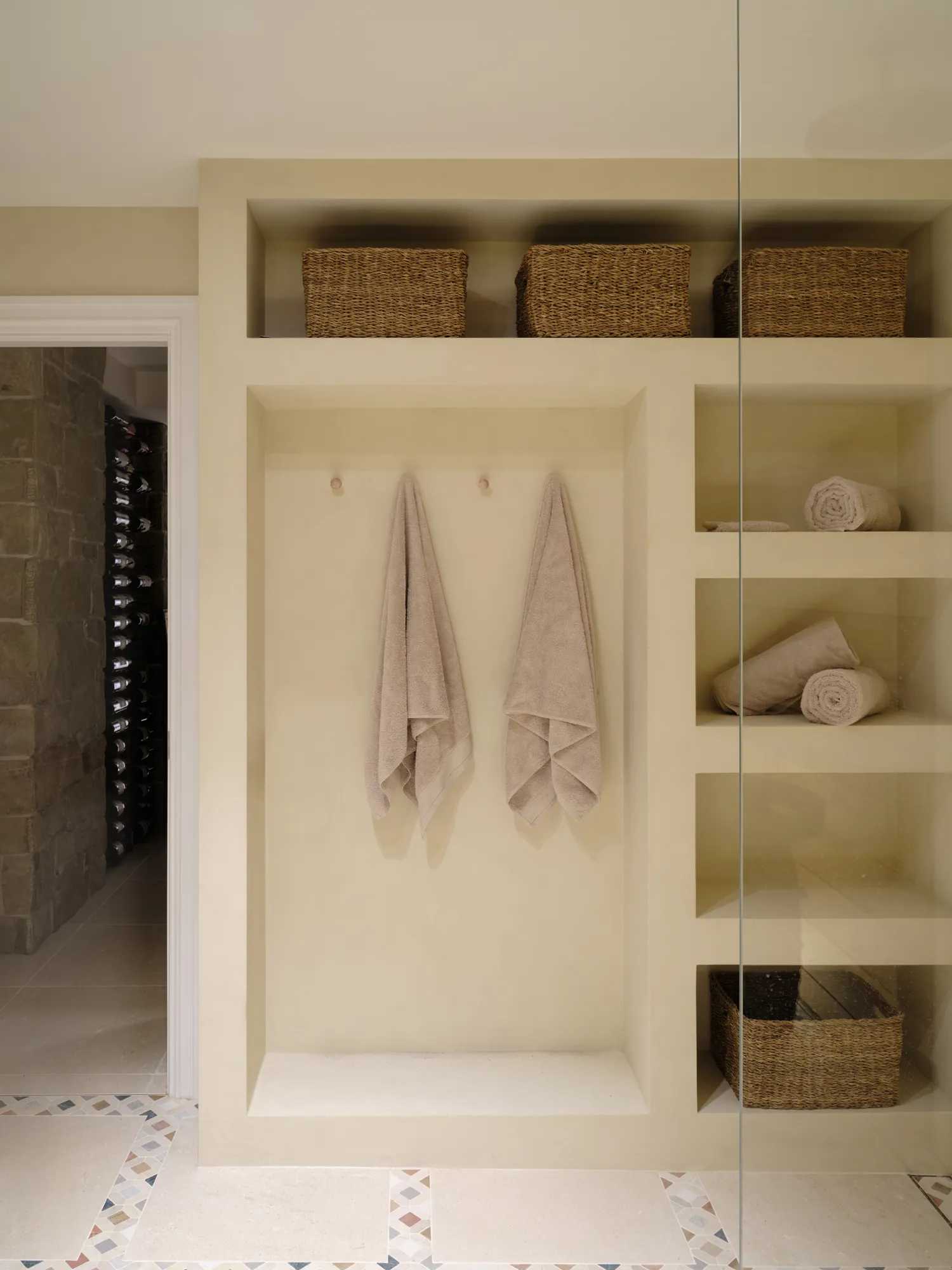 Basement wellness niche with towels and baskets.