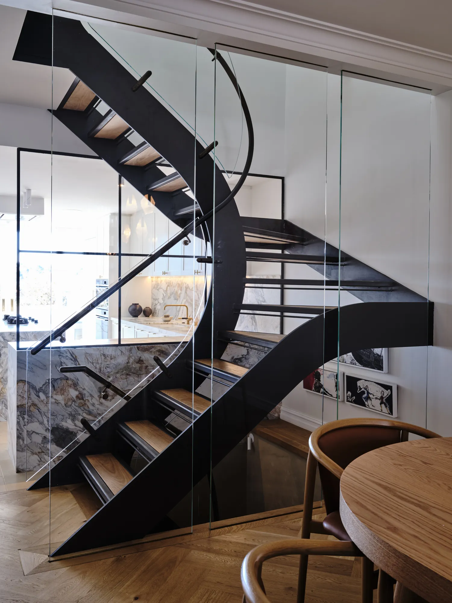 Steel stair rising over the dining area.