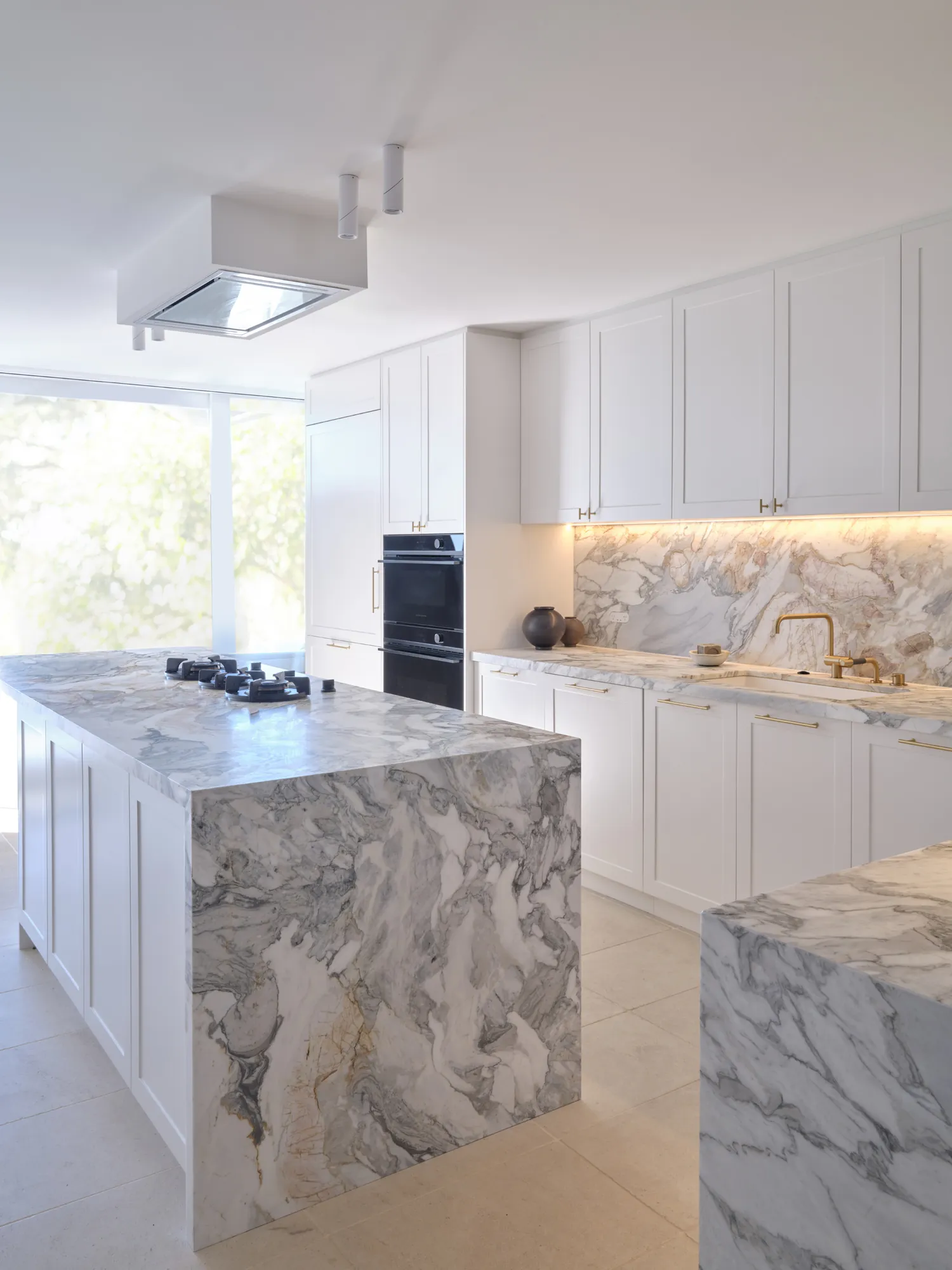 Kitchen with marble waterfall island.