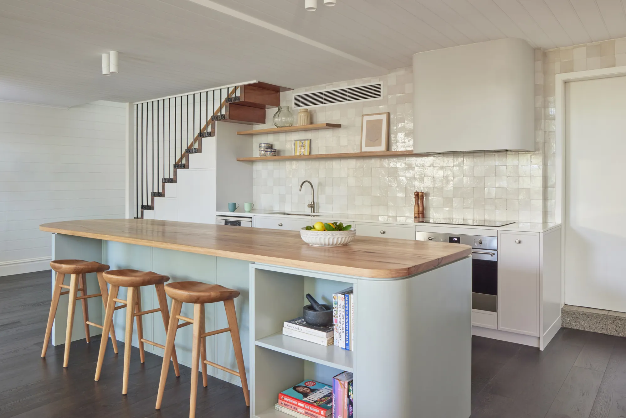 Island, open shelving and the white VJ stair.