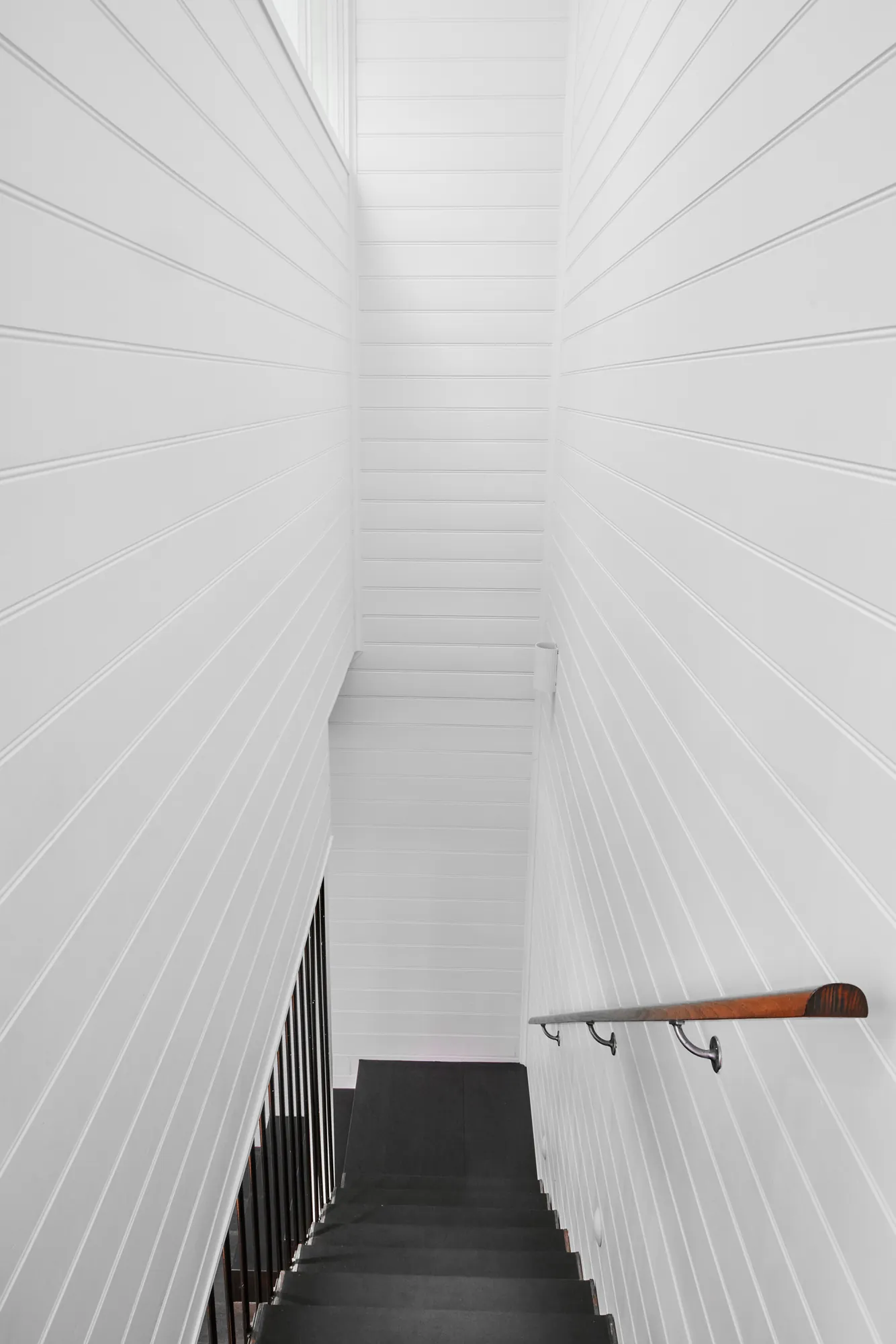 Stairwell with timber handrail.